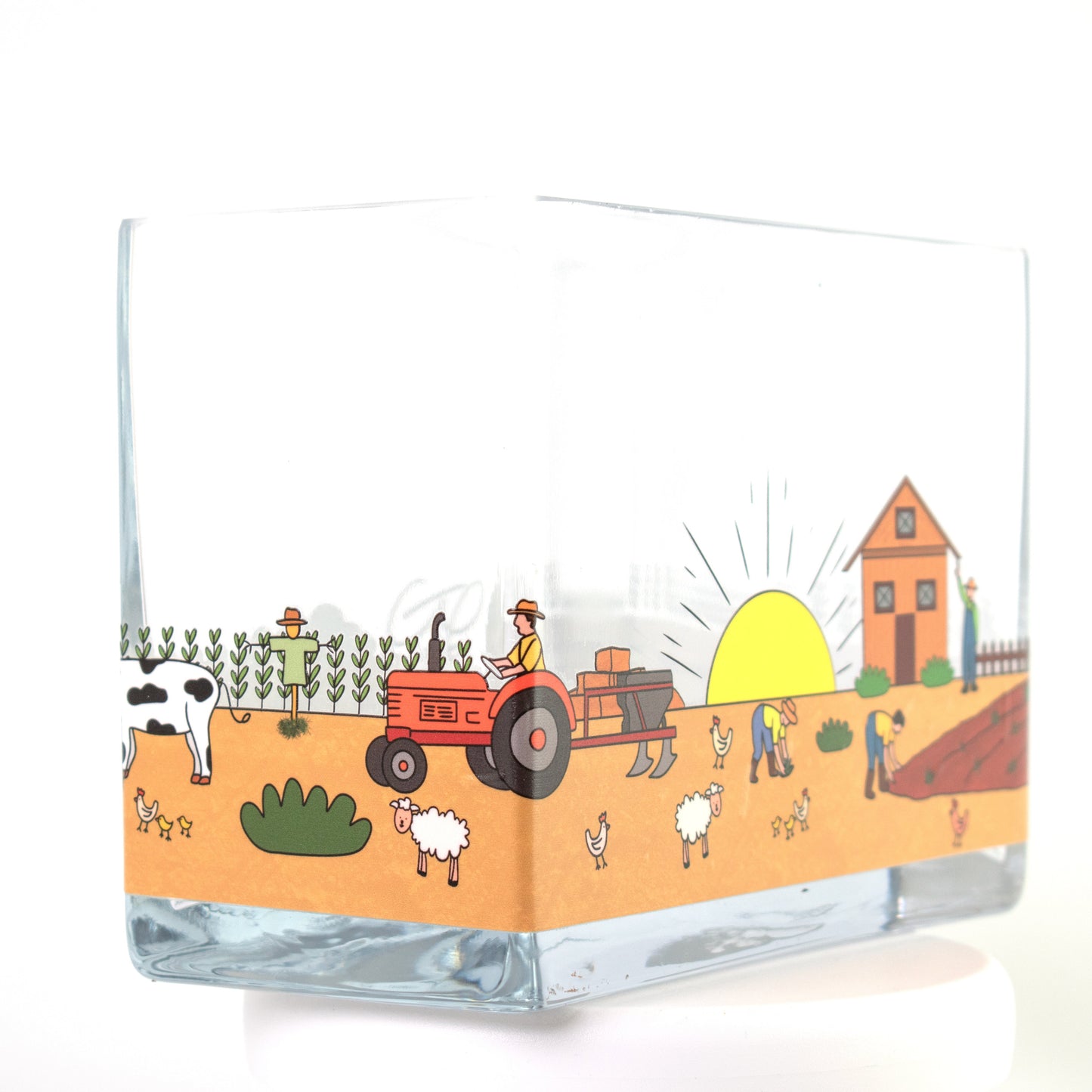 Clear glass vase with a colourful farm design featuring sunrise, barn, farmers, tractor, and animals — size 20x10x15 cmH.