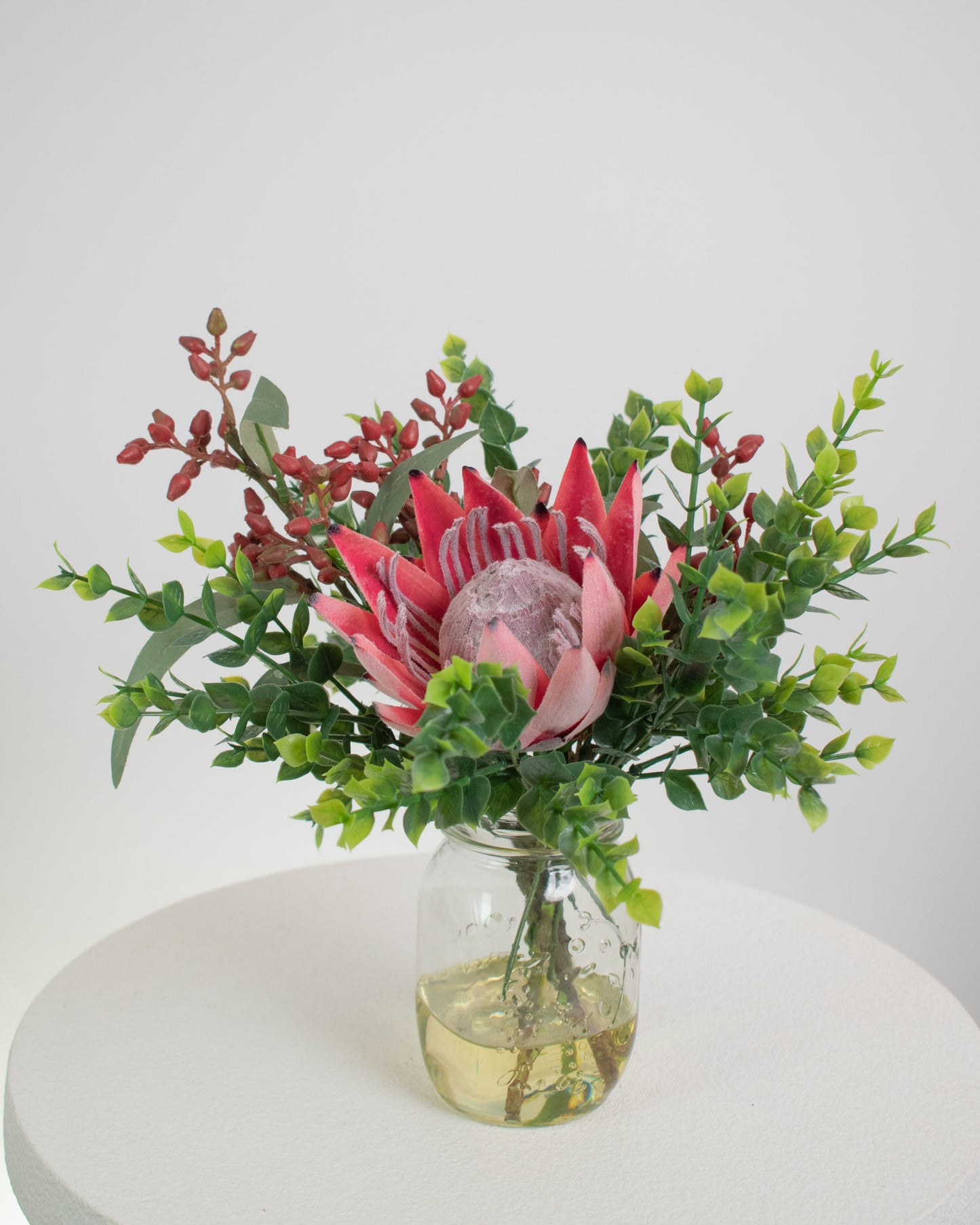 striking artificial protea flower as the centerpiece,