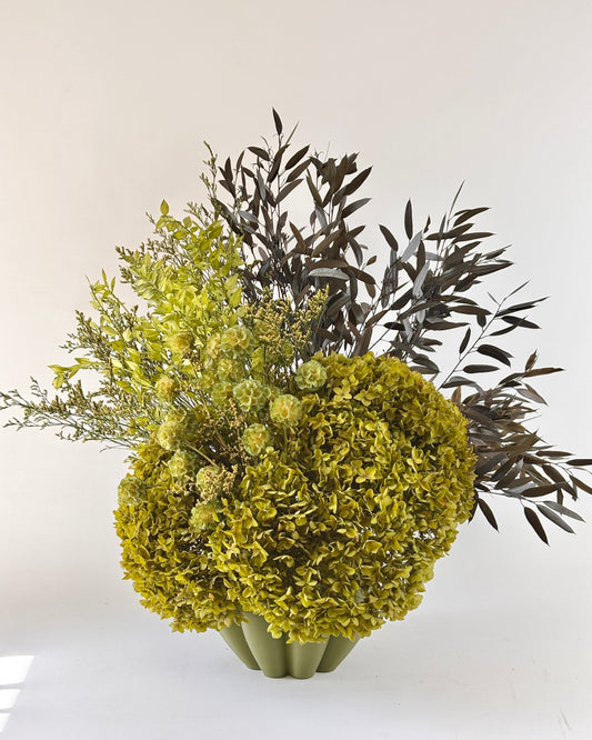 Bouquet of green flowers in a vase on a white background