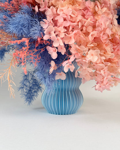 Blue vase pink flowers