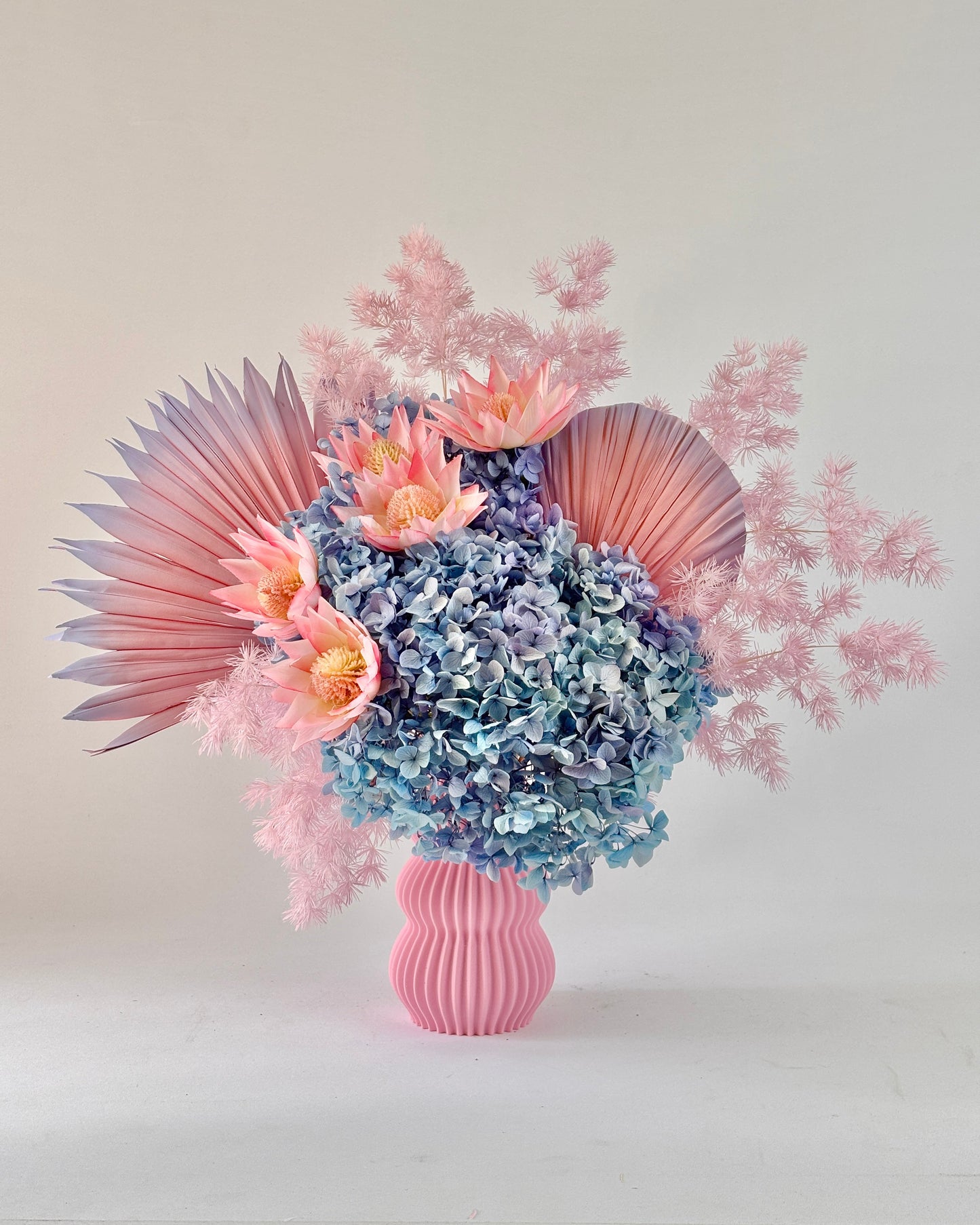 Bouquet of dried flowers in a pink vase