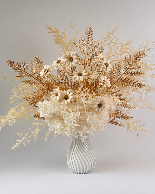 Bouquet of dried flowers in white and gold with a white vase 