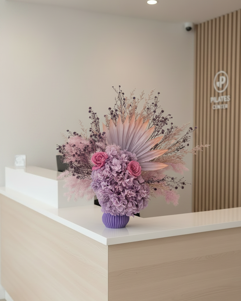 Decorative dried floral arrangement on a reception desk with a neutral background
