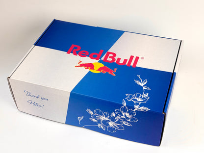 Red Bull branded box with floral design on a white background
