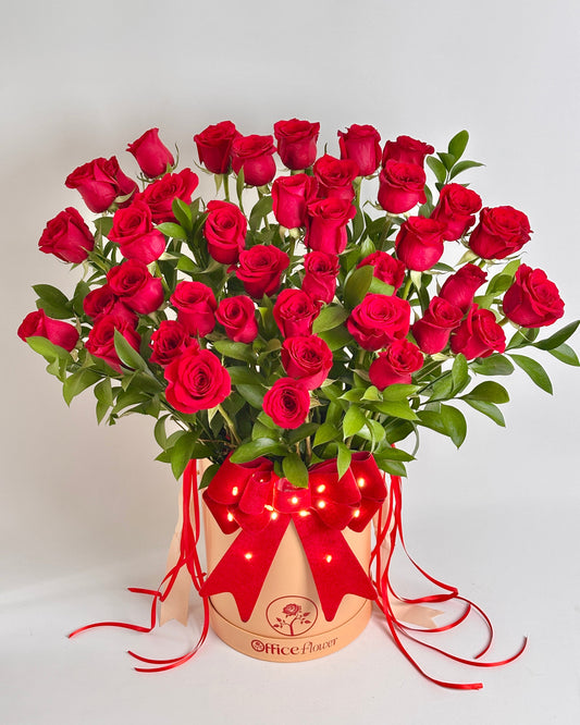 Bouquet of 50 red roses in a decorative box with a red ribbon 