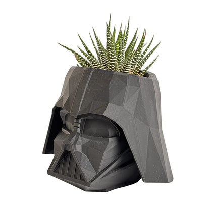 Geometric wall art piece on a white background with a plant.