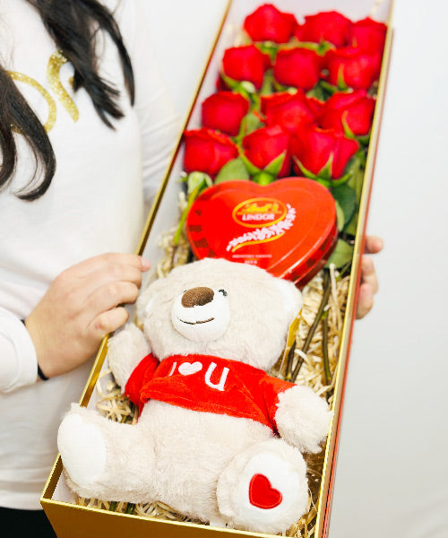 Red Roses Luxe Box from OfficeFlower featuring 12 or 24 premium red roses, an optional teddy bear, and heart tin chocolates