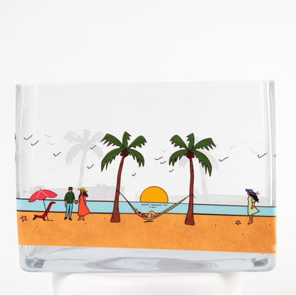 Tropical Sunset Glass Vase Featuring a charming seaside illustration with palm trees, gentle waves, and a glowing sunset, this vase captures the feeling of relaxation and escape.