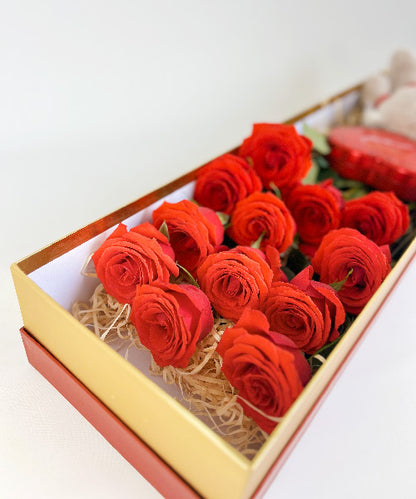 Red Roses Luxe Box from OfficeFlower featuring 12 or 24 premium red roses, an optional teddy bear, and heart tin chocolates