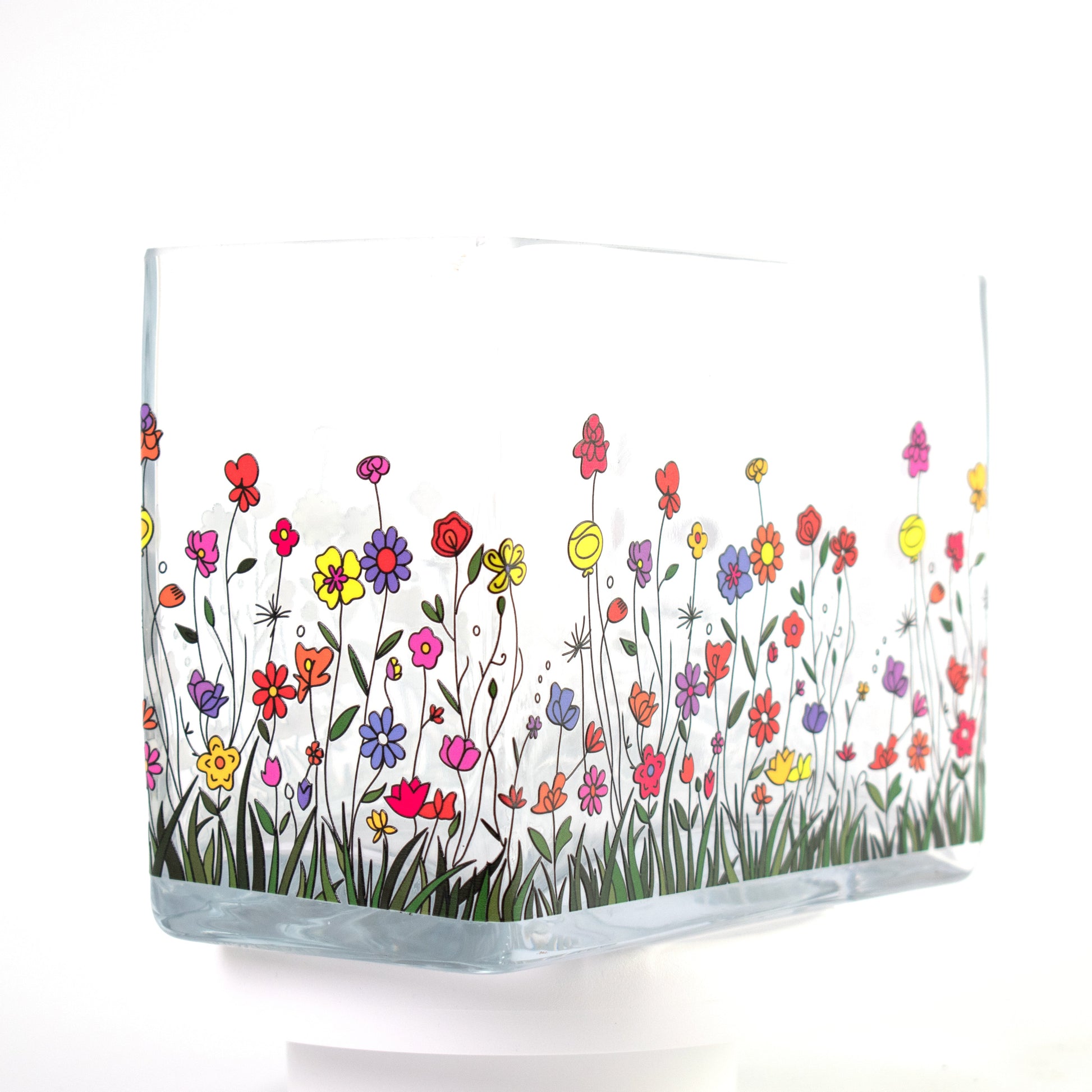 Clear glass vase with a colourful wildflower design featuring red, purple, yellow, and orange flowers — size 20x10x15 cmH.