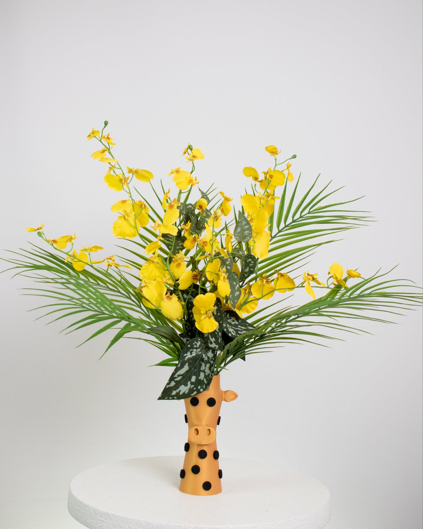 Yellow flowers in a giraffe-shaped vase